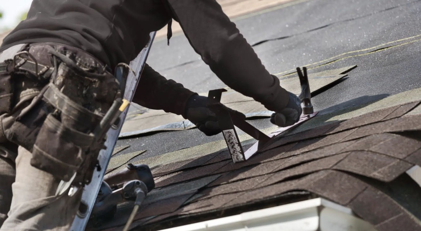 Professional roof repair contractor fixing damaged shingles in Cypress, CA
